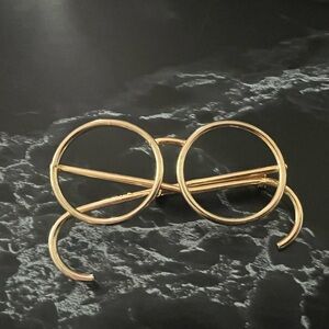 Spectacle gold tone brooch